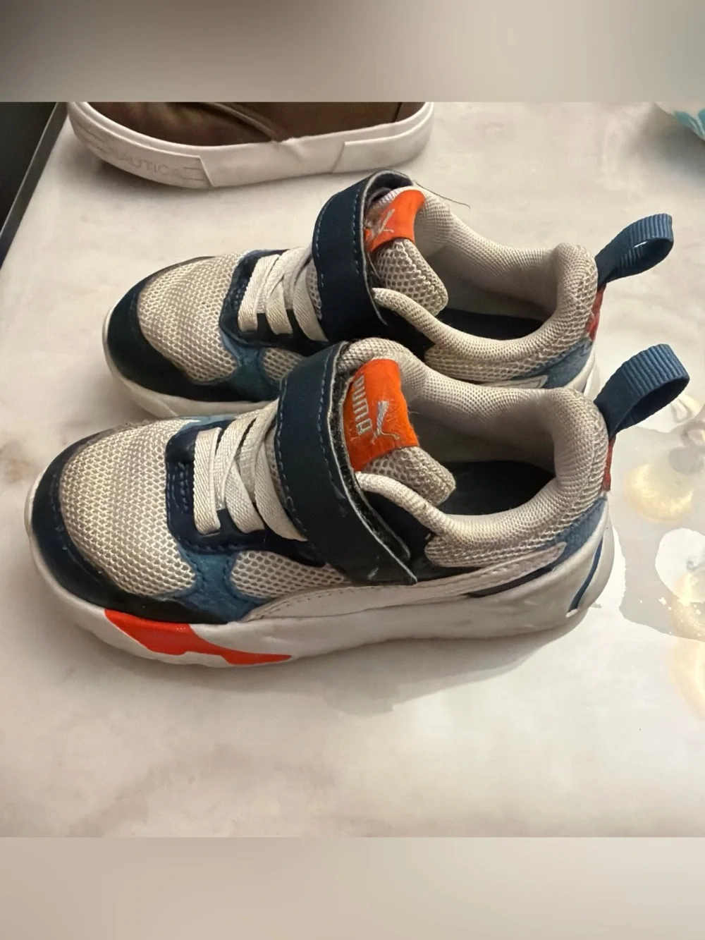 Puma Kids White and Navy Sneakers with Orange Logo Accent